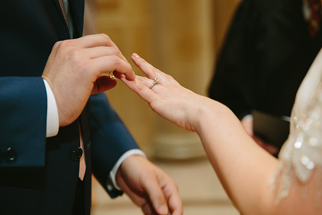San Francisco wedding
photographer, closeup of groom placing wedding ring on his bride's hand during their San Francisco City Hall wedding ceremony