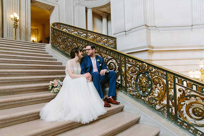 San Francisco wedding
photographer, bride and groom sitting on Grand Staircase inside San Francisco City Hall