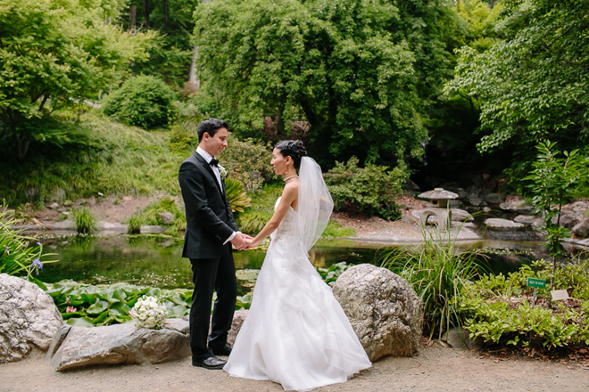 Bride and groom standing in front of the Japanese garden at the UC Berkeley Botanical garden