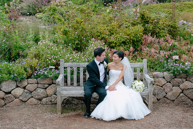 Bride and groom sitting on bench at their UC Berkeley Botanical Garden Wedding