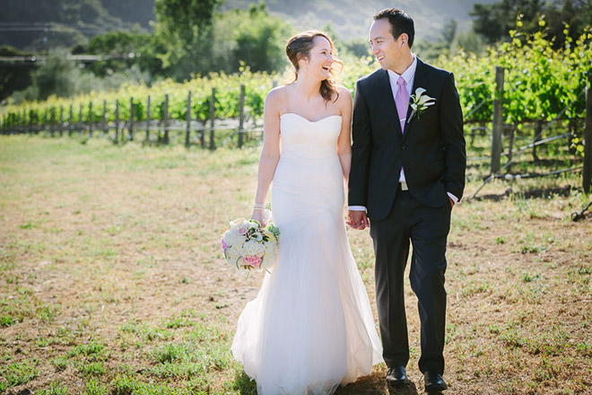 Bride and groom standing in vineyard in Carmel