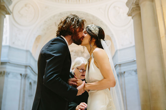 San Francisco City Hall wedding, Bride and groom kiss during their ceremony