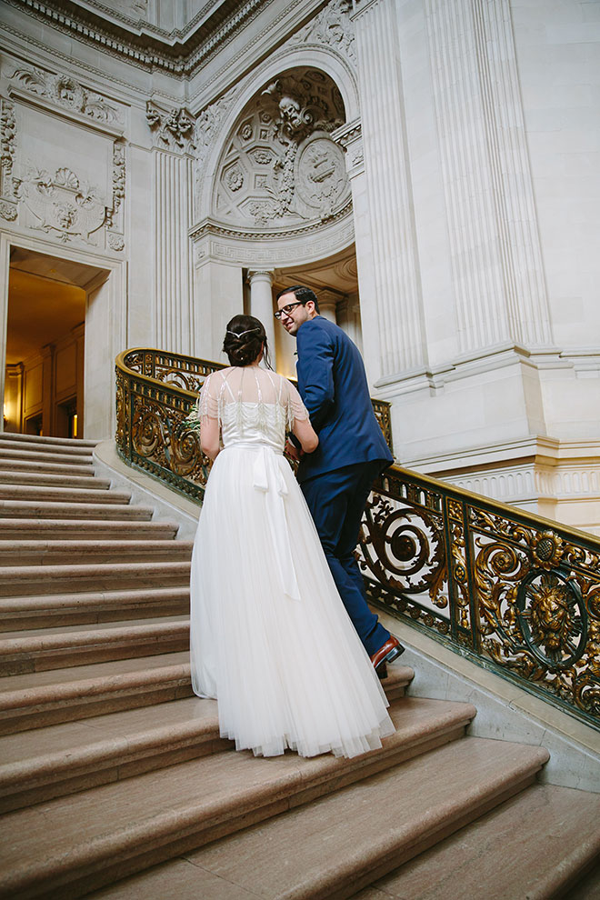 San Francisco wedding
photographer, bride and groom walking on Grand Staircase inside City
Hall