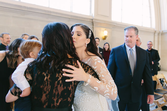 San Francisco wedding
photographer, bride kisses her mother during wedding ceremony at San Francisco City Hall