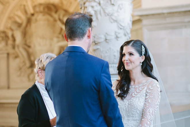 San Francisco wedding
photographer, bride looks at groom during wedding ceremony at San Francisco City Hall