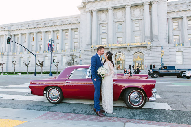 San Francisco wedding
photographer, bride and groom with a red, vintage Thunderbird class car at their San Francisco City Hall wedding